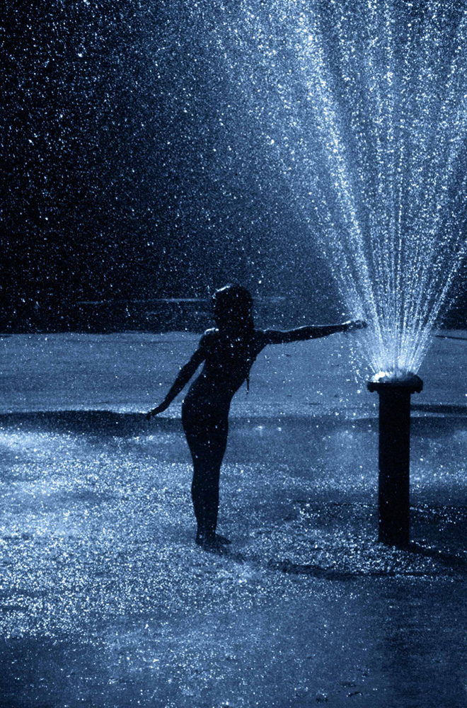 Girl in sprinkler